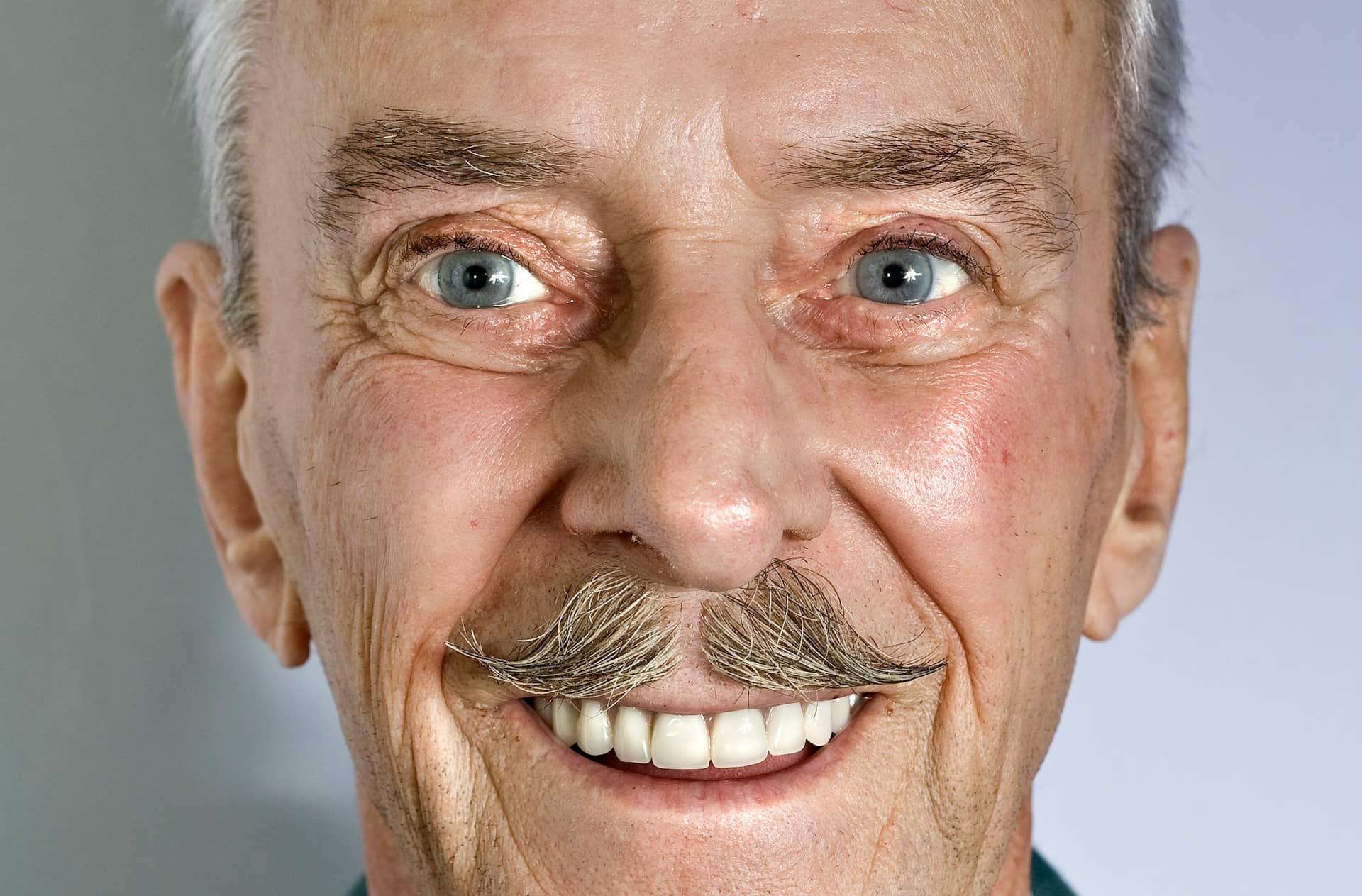 Close-up photo of a mature man's face, expressing the resilience and wisdom associated with male longevity.