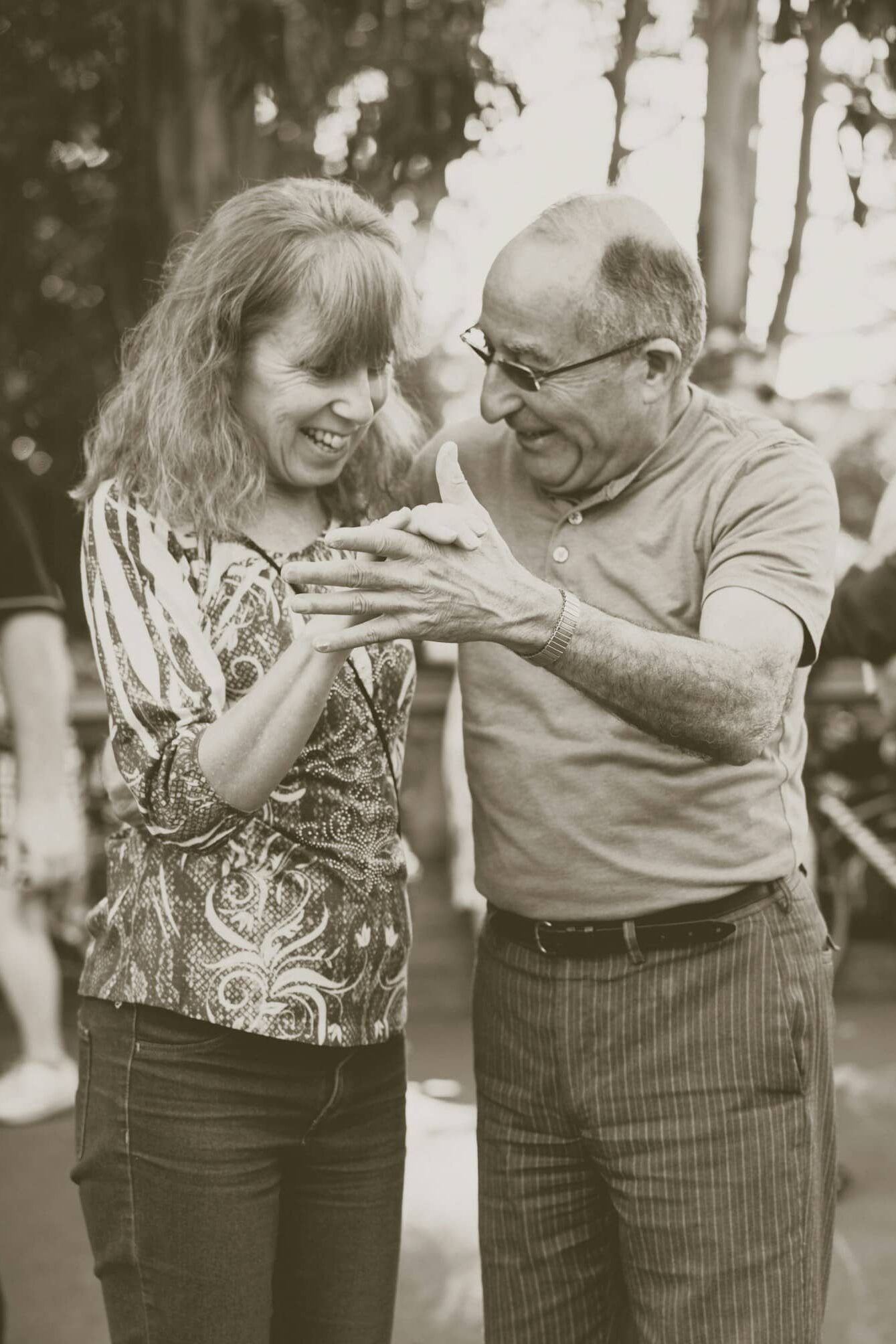 Vital elderly couple dancing in a party with more people