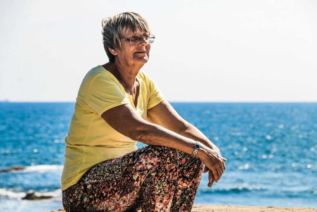 Woman sitting on seashore